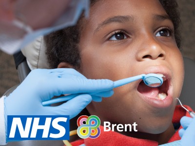 Boy has his teeth checked with NHS and Brent logos