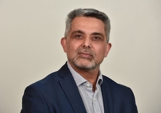 Headshot of a man in a suit - the Leader of Brent council, Muhammed Butt