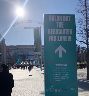 Image of  Wembley Stadium with a sign for the designated drink area