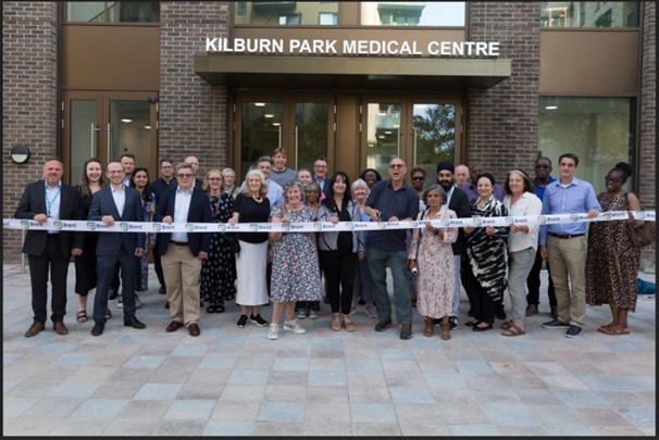People standing infromt of the new Kilburn Park medical Centre at the opening event