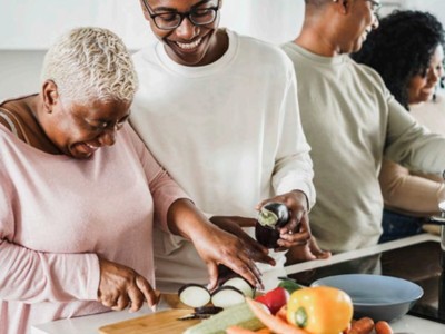 older black women cooking with family