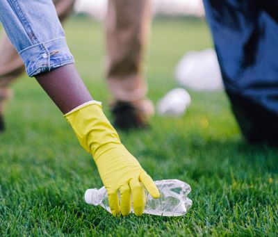 Person picking up rubbish of ground