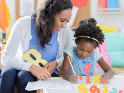 teacher and girl with illustrated numbers