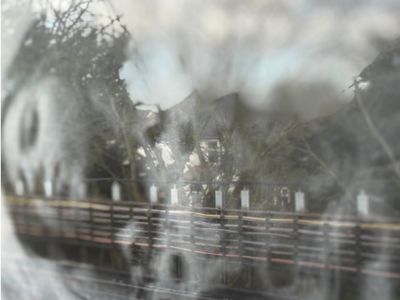 Black and white photo of a woman superimposed onto an image of a railway line