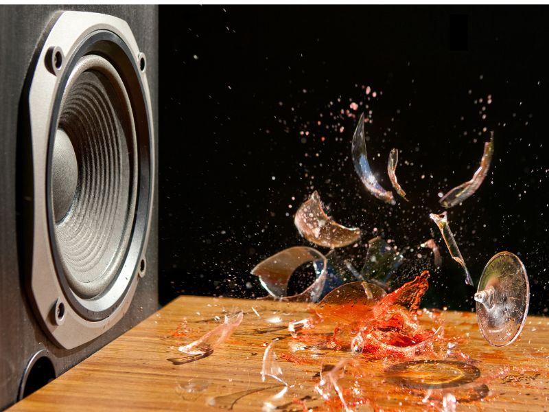 Speaker blaring loud music that breaks a glass
