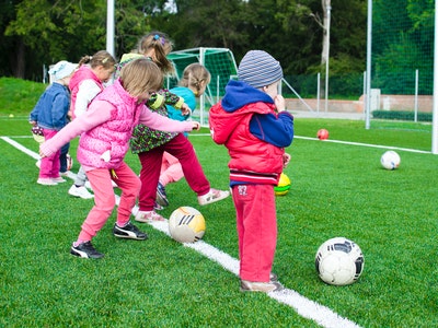 Image of a group of kids playing football..