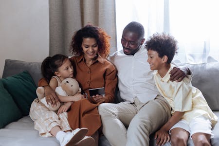 image of a family sitting on a sofa