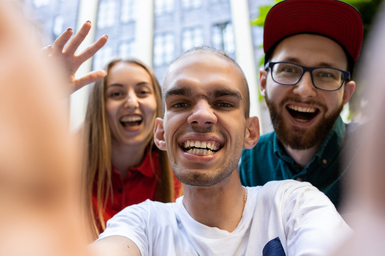 Three young people smiling at the camera