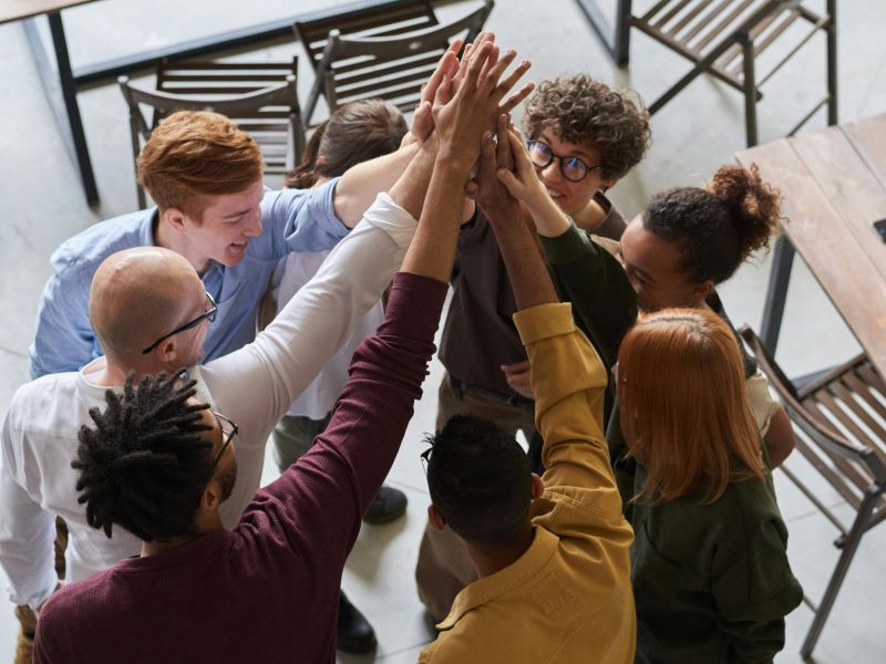 Group of office workers hi five