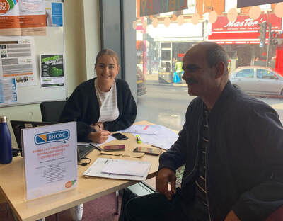 Image of woman giving advice to person at a support desk