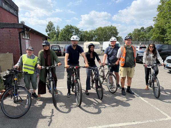 Group of people sitting on repaired bikes