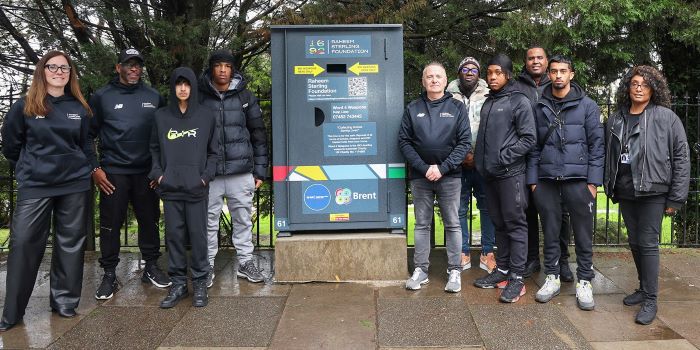 The Raheem Sterling Foundation boys standing next to knife bin