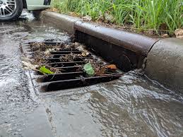 road gully with water running