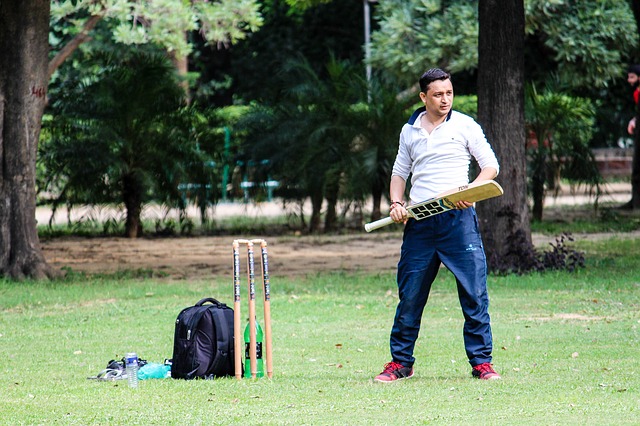 Man playing cricket on a pitch