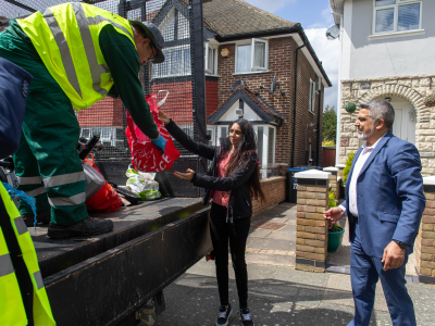 Cllr Sheth and Cllr Butt hand recycling to a colleague at one of our community skips