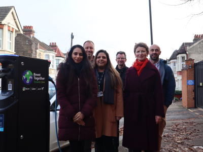 Cllr Sheth, colleagues, zest and uber employees pose for photo in front of a new electronic charging point