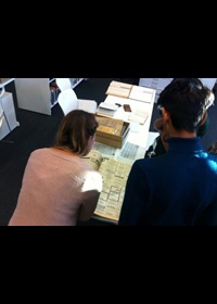 Two people looking over archive documents in Search Room