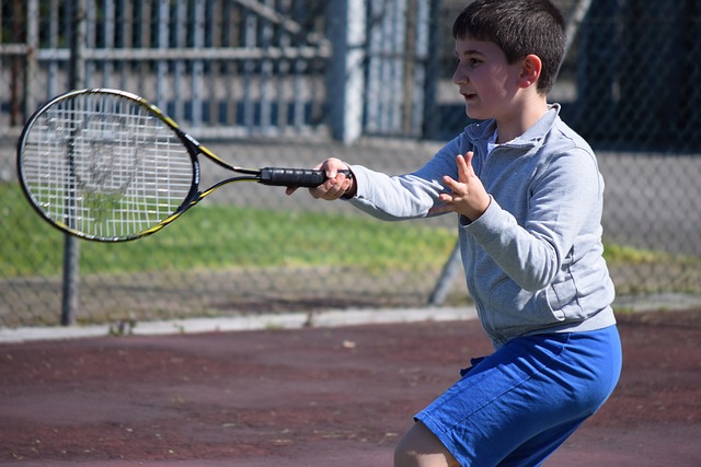 Boy playing tennis on a tennis court