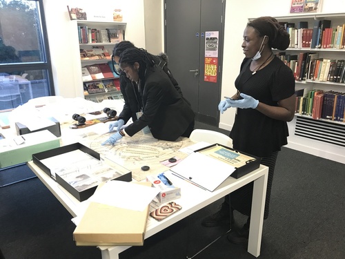 Young people looking at source material from the Brent Museum and Archives collection